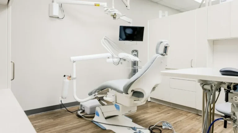 Gabinete de una clínica dental moderna con sillón y monitores