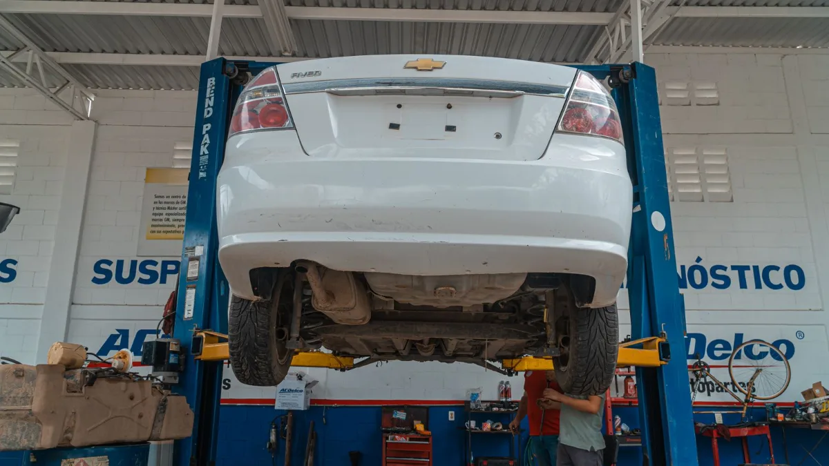 Coche elevado en un taller mecánico durante una revisión